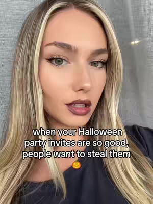 A close-up shot of a young woman with long blonde hair and dark eye makeup. She has a light complexion, and her lips are painted dark. Text overlays the image in a bold, white font.