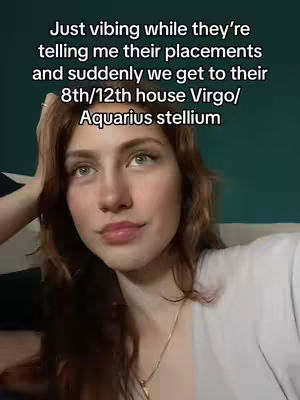 A young woman gazes upwards with a gentle smile, her auburn hair casually framing her face. Text overlayed on the image conveys astrological themes against a soft, teal green backdrop, promoting an engaging and friendly vibe.