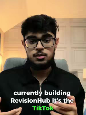 A young man with dark hair and glasses is centered in the frame. He's wearing a black zip-up jacket. Below, overlaid text calls out the name of an app he is building, RevisionHub, as the TikTok.