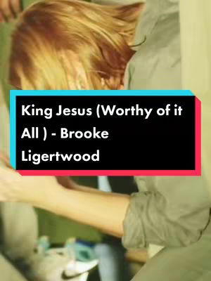 The image shows a person with blonde hair from the back, looking downward. A rectangular text overlay dominates the bottom-center with the title of a song.