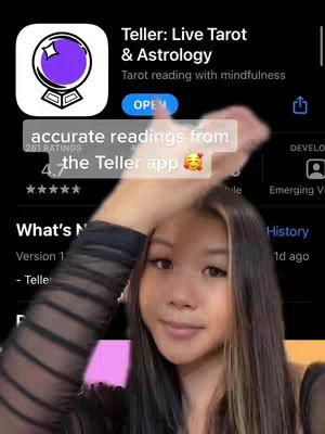 A young woman is holding a smartphone screen showing an app interface with a tarot card theme, overlaid with text. The woman is smiling and giving the camera a friendly look, and her hand is partially obscuring the screen.
