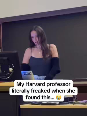 A young woman stands behind a desk with a laptop, looking downward in a classroom setting. Text on the screen indicates it's a YETI laptop. Text overlaid on the bottom explains the situation.