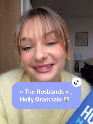 A woman with blonde hair and bangs smiles at the camera, holding a book. A text overlay in a blue rectangle with rounded corners is placed over her face, showcasing the title and author of a book.