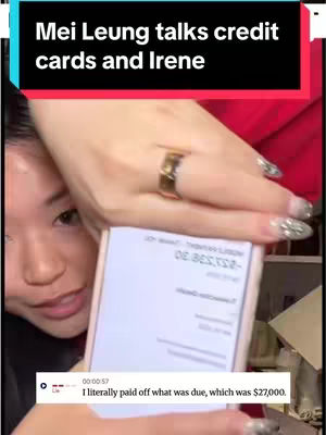 The cover image shows a person's face obscured by the hand of another person. The primary focus is on the hand, which holds a mobile phone displaying a credit card statement. The person has long nails with decorative elements. The background shows the arm and shoulder of a person wearing a red garment. At the bottom of the image, there is a text box overlay showing a statement related to $27,000.