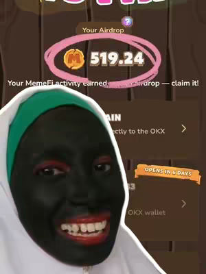A person with their face and neck painted black smiles broadly at the camera. Their outfit has a hood, and they are holding an app interface visible in the background. The interface has a coin and a dollar-value inside a pink circle. Text is visible on the interface and in the background.