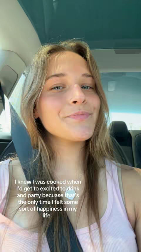 The cover image shows a young woman in the front seat of a car, looking directly at the camera and smiling slightly. She has long, light brown hair and is wearing a light pink tank top. The background indicates it could be the interior of a car, with a seatbelt visible.
