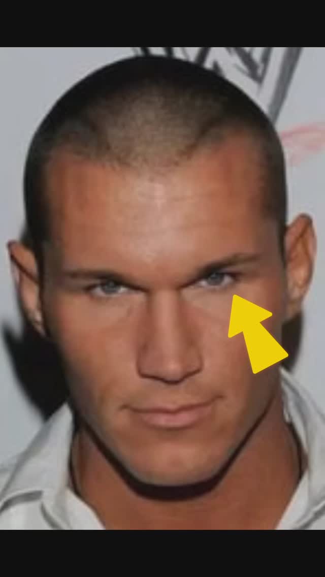The cover image is a close-up shot of a man's face, likely Randy Orton, with a light-colored skin tone and short, dark hair. He has a stern expression with deep-set, blue eyes. A bright yellow arrow points to his eye. A white collar shirt is partly visible in the frame. The background is light gray, providing contrast for the man's face. The overall composition is simple, focusing on the man's facial features.