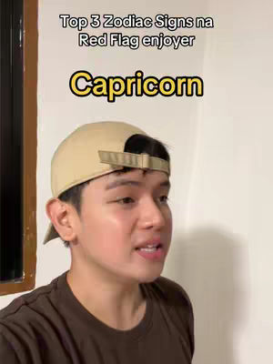A young man wearing a brown shirt and a beige cap looks towards the camera with an earnest expression. Above him, text reads 'Top 3 Zodiac Signs na Red Flag enjoyer' and beneath him, 'Capricorn' in a yellow outlined black text, suggesting a focus on astrology.