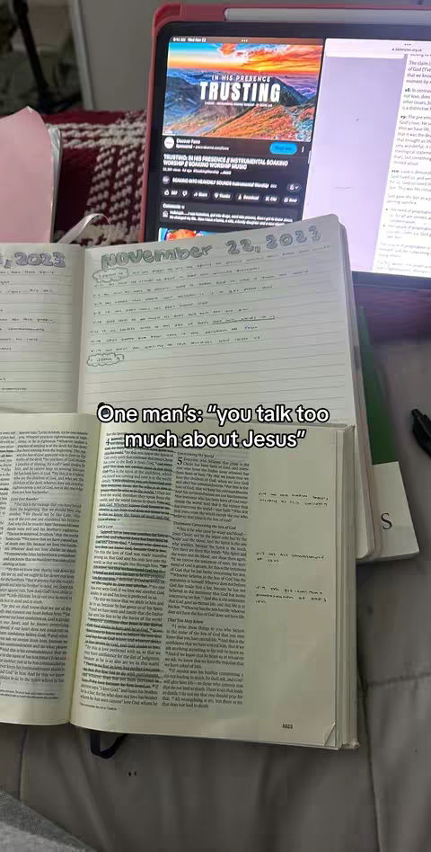 The image shows an open notebook and a Bible, with a tablet displaying text and a YouTube video on a table. The notebook is open to a page with handwritten notes, and the Bible is open with text visible. The tablet screen displays a YouTube video titled "TRUSTING" by Discover Pete. The overall scene conveys a sense of study, faith, and possibly Bible study or journaling.