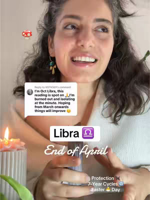 A woman with dark curly hair is the central figure, looking upward with a slight smile. A light-colored sweater covers her shoulders. Overlaying the image is a speech bubble containing text, and a banner with the word "Libra" and the end of april text. A lit candle is positioned in the lower left corner and a little mushroom.