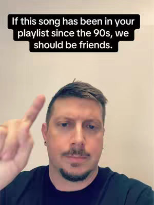 A man with short brown hair and a mustache is pointing his index finger upwards. A black overlay at the top includes white text.