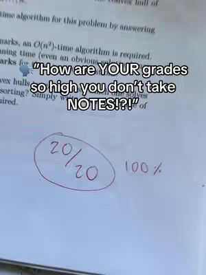 A close-up shot of a piece of paper with a math problem, and the text overlayed, the paper is in a slightly angled position and a big circle is drawn around the 20/20 score which is written on the paper. 