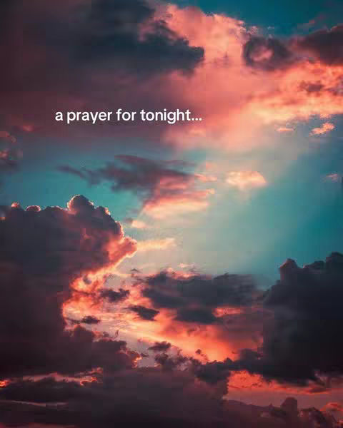 A vibrant image of a sunset with a mix of orange, pink, and blue hues highlighting the sky. Wispy clouds add texture with the text 'a prayer for tonight...' overlayed on top.
