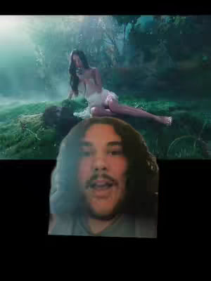 The cover image is split into two sections, with the top half showing a scene of a woman, possibly singer Olivia Rodrigo, in a natural setting. She is wearing a white dress and lying on the grass. The bottom half features a selfie of a man with a surprised expression, his mouth open, with long dark hair and a mustache.
