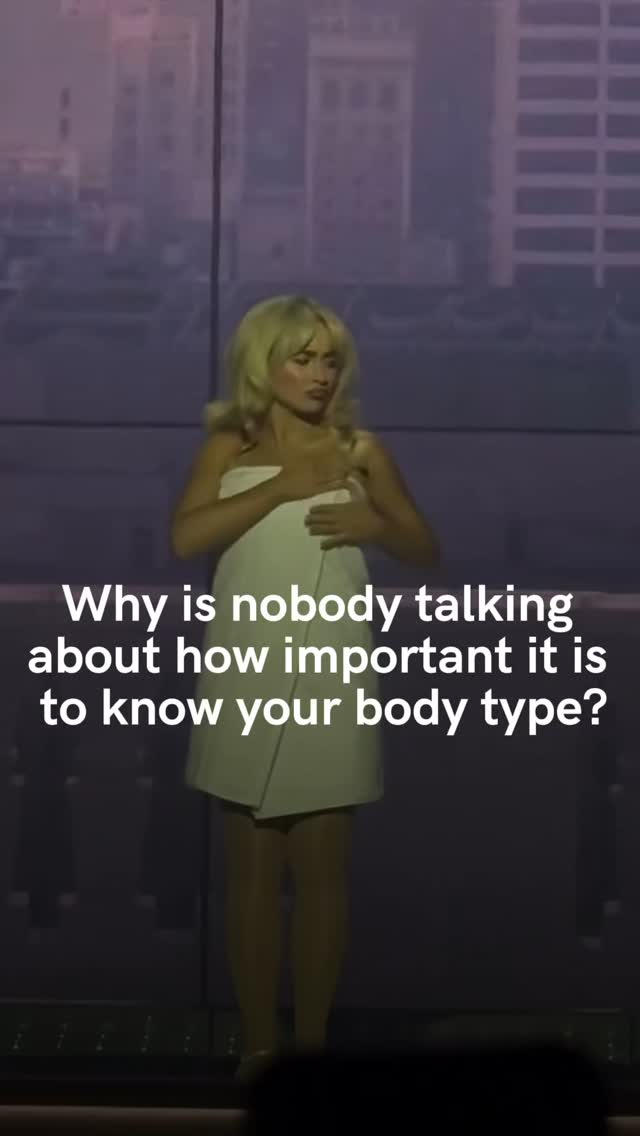 A woman with blonde hair is standing in front of a blurred background, likely on a stage. She's wearing a white towel-like garment, covering her body. Text overlayed on the image asks "Why is nobody talking about how important it is to know your body type?"