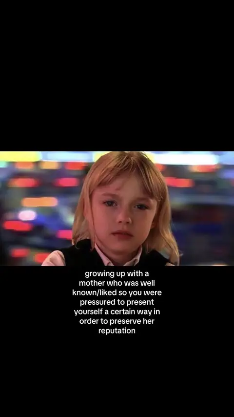 A young girl with blonde hair and a serious expression is the focal point of the image, set against a blurry, colorful background. The girl is situated in the center of the frame from mid-chest up, her gaze directed off to the side. Below her, a text overlay provides context, using a simple, sans-serif font in white against a black background.