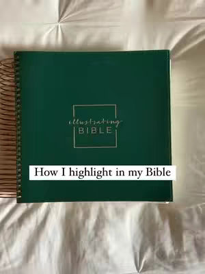 The image shows a closed, green, spiral-bound book, presumably a Bible, resting on a white, textured surface, likely a bedspread. A white rectangular text overlay at the bottom reads, "How I highlight in my Bible."