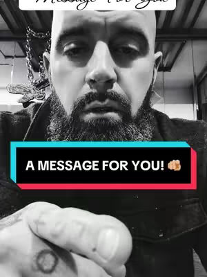 A black and white, close-up portrait of a man with a full beard and shaved head. The man is looking towards the camera. Overlaid on the image is a black and pink rectangular box with white text that reads "A MESSAGE FOR YOU!".