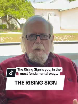 A man with glasses and a white beard is centered in the frame, against a blurred background of greenery and a white building. A white box with black text overlaying the man's chest says 'The Rising Sign'. The TikTok logo graphic is in the top left of the box.
