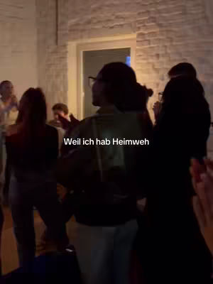 The cover image shows a group of people in a brightly lit room, with a woman's back to the camera, and text overlayed on the image.