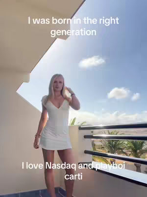 A woman in a white dress stands on a balcony with a blue sky and clouds as a backdrop. Text overlays are present on the image.