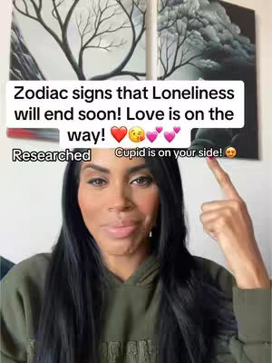 The cover image shows a woman with long, dark hair centered against a white background, with two framed art pieces behind her. A text overlay sits above her head, while she points upwards. The image has a clear, well-lit composition with focus on the woman's face.