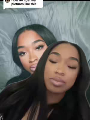 The cover image features two women with similar hairstyles and facial features. One woman is in the foreground, facing slightly towards the camera, with a neutral expression. The other woman is positioned behind her, looking towards the camera. The image is in vertical format. The background is blurred.