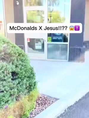 The cover image shows a close-up of a glass door entrance to a McDonalds, with a sign on the door. Above the door, a text overlay reads "McDonalds X Jesus!!??" with emojis. There is some greenery, bushes and the sky in the frame.