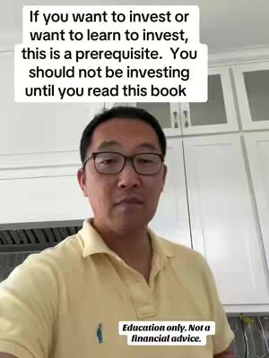 A man in a yellow polo shirt wearing glasses is centered in the frame with a white text overlay on top. Behind him are white cabinets and countertops.