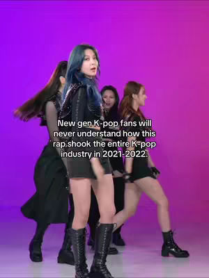 The cover image shows a group of five women in a dance pose. The background is a gradient of purple to pink. The women are dressed in black outfits with intricate details, and they are wearing boots. Text overlay is placed on the image.