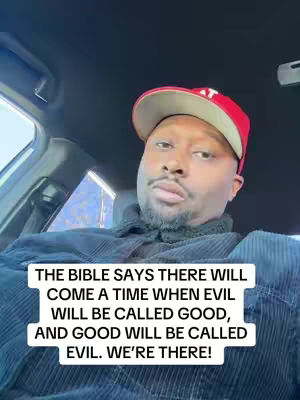 A man wearing a red cap and dark clothing is seated in a car. A white rectangular text box at the bottom features text about a biblical prophecy regarding good and evil.