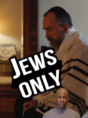 The cover image features a split composition. On the right, a man wearing a tallit (Jewish prayer shawl) and a yarmulke is seen from the shoulder up, his face in profile looking down pensively. In the background, a table with a Star of David-decorated item is visible, and other objects, suggesting an indoor setting. At the bottom, a man with a shaved head is looking towards the viewer. Overlaid across these figures is a bold, black rectangle with the words 'JEWS ONLY' in large, white, impactful font.