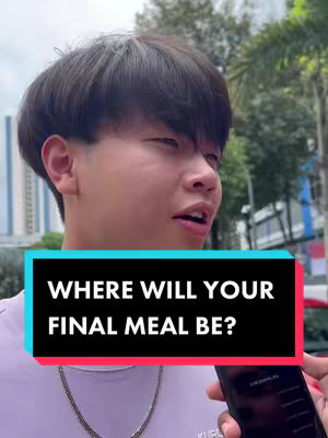 A young man with short, dark hair is centered in the frame, slightly angled towards the left, against a blurred outdoor background. He appears to be speaking, mouth open, and looking towards something off-camera. A text overlay in a rectangular box at the bottom of the frame poses a question in large, white capital letters on a colored background. He wears a light-colored shirt and a silver chain.