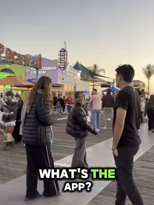 The cover image shows a seaside boardwalk with several people walking around. Three people are the focus: Two women in black jackets are talking to the camera while a man stands on the right side.