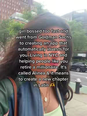 The image is a selfie-style shot featuring a woman with long, dark hair. Text overlays the image and includes information about an app designed to help people invest, mentioning creating a new chapter in Latin. The background is blurred, suggesting an urban setting.