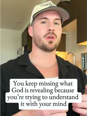 A man wearing a cap is speaking directly to the camera, with a text overlay at the bottom.
