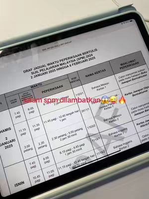 A table with exam details displayed on an iPad. Text overlays indicate the exams and include the phrase "spm dilambatkan" (SPM postponed).