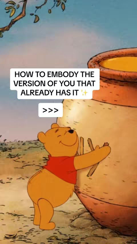 A cartoon image of Winnie the Pooh, in his typical yellow color but wearing a red shirt, leaning against a large honey pot. The background is a soft blue sky with some tree branches. A text overlay in a white box at the top reads 'HOW TO EMBODY THE VERSION OF YOU THAT ALREADY HAS IT' with '>>>' and sparkles.