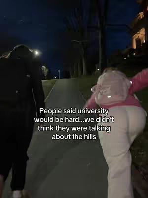 Two people walking away from the camera at night along a dimly lit path with text overlaid on the image.