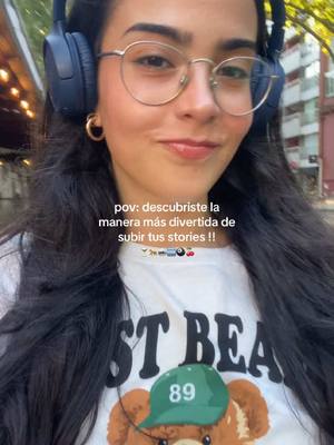 A selfie taken from a medium angle featuring a young woman with long, dark hair, glasses, and headphones. Text overlays the image, while she wears a white t-shirt and smiles at the camera, surrounded by an outdoor setting.