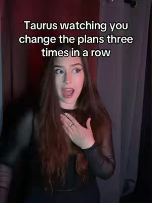 A woman with long brown hair is in the center of the image, her mouth open in an expression of surprise. She's wearing a black top. Text in white letters overlays her head.