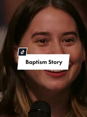 A woman is looking slightly upward and to the side as she speaks, mid-sentence, smiling. Behind her, the backdrop is blurred. The main text overlay, "Baptism Story", is centered on a white bar with black text, in a sans-serif font.