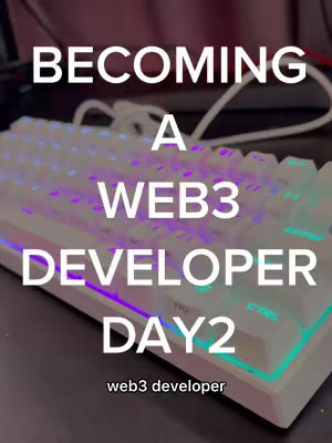 The cover image features a close-up shot of a white keyboard with multi-colored LED lighting. The text overlayed on the image reads 'BECOMING A WEB3 DEVELOPER DAY2' in bold, white font. Below the text, there is a smaller text that says 'web3 developer'. The composition emphasizes technology and learning.