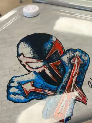 The cover image features a stylized illustration on a light grey surface. The design appears to be a painting of Spider-Man 2099's mask and arm holding an arrow-shaped object. The color palette mainly uses blue, black, and red, with some white highlights giving a sense of depth.