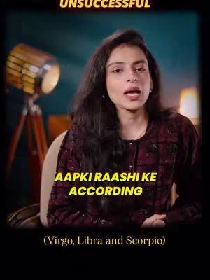 A woman with long dark hair is centered in the frame, looking upwards and speaking. Text overlays appear, with the word "UNSUCCESSFUL" at the top. A lower text overlay reads "AAPKI RAASHI KE ACCORDING" in a yellow font. Below, the text clarifies "(Virgo, Libra and Scorpio)". A large lamp on a tripod is visible in the background, with additional lighting giving the scene a warm glow.