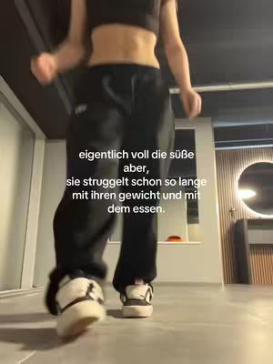 A full-length shot of a person in black athletic wear and white shoes. Text in German is overlaid on the image.
