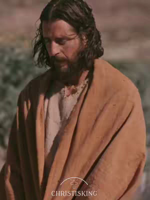 The image shows a man with long, brown hair and a beard looking downcast. He's wearing a draped, tan garment. The background is a blurred, earthy tone. The bottom of the image includes text and a logo indicating the content is related to "Christisking".