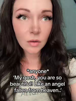 A woman with long dark hair and green eyes gazes intently at the camera.  Overlayed text appears in white at the bottom of the screen.