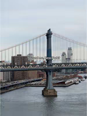 The cover image shows a view of the Manhattan Bridge in New York City. The bridge is the central element of the image, with its tall towers and suspension cables prominently displayed. The cityscape of New York is visible in the background, with skyscrapers and other buildings. The water of the East River is in the foreground. Overlaid on the image is the text 'You and me, New York?'