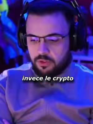 The cover image is a close-up shot of a man wearing glasses and a headset, with a dark background lit with purple and blue lights. The man has a beard and is looking down. Text overlayed at the bottom of the shot reads 'invece le crypto' in a white font.